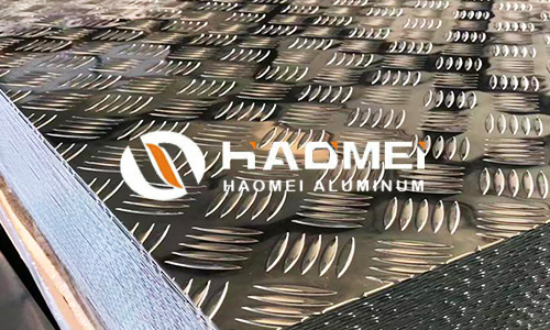 Piles of 5754 aluminum checkered plate sheets Piles of 5754 aluminum checkered plate sheets