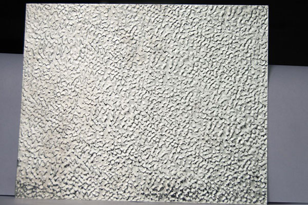 This shows a peice of stucco embossed aluminum sheet.
